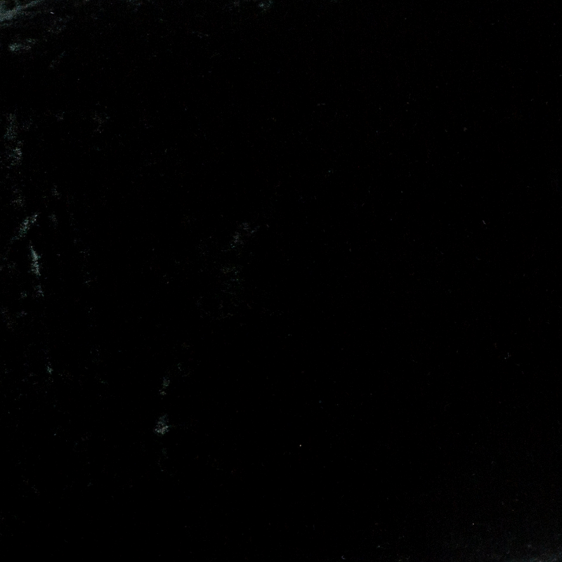 Loulah Blanket | Juniper | A close up of silk velvet fabric in Juniper, a deep green tone.