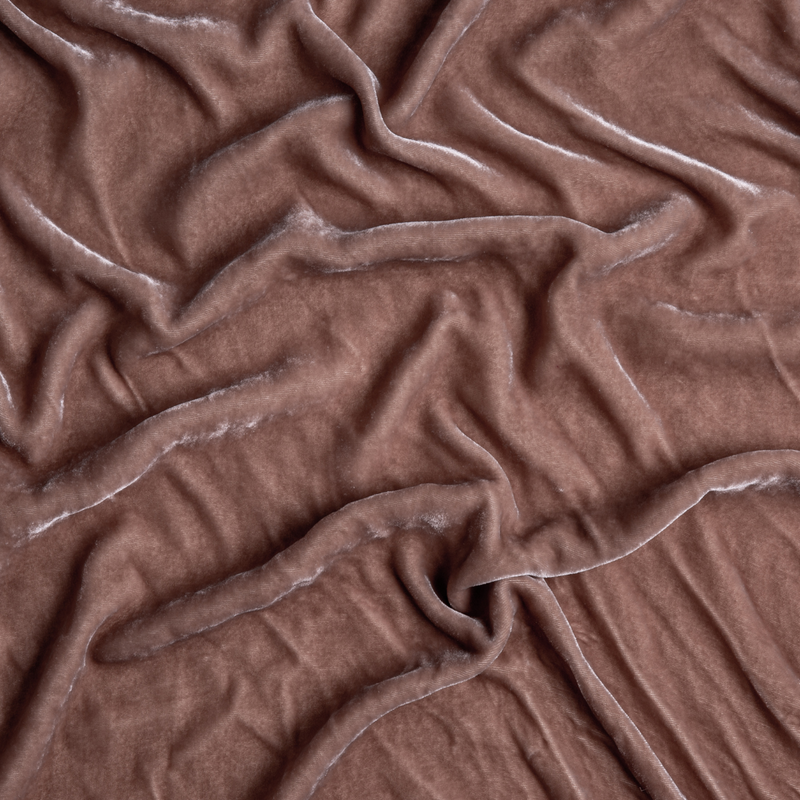 Carmen Blanket | Rouge | A close up of silk velvet fabric in rouge, a mid-tone blush pink.