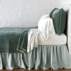 Silk Velvet Quilted Coverlet | Eucalyptus | coverlet with matching shams and white sheeting - side view.