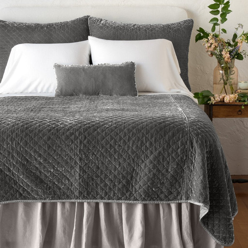 Silk Velvet Quilted Sham | Fog | shams with matching coverlet on a neatly-made, bed with white sheeting - end of bed view.