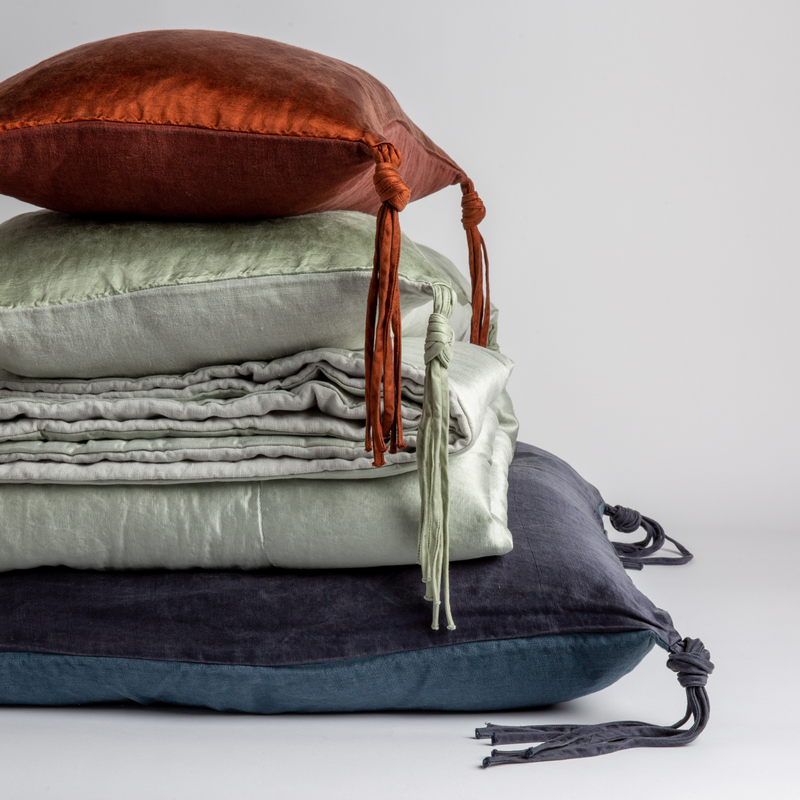 Taline Blanket | throw pillows and blanket offered in the taline collection shown against a white background. 