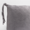 Taline Throw Pillow | French Lavender | close up of a charmeuse pillow corner and tassel against a white background.