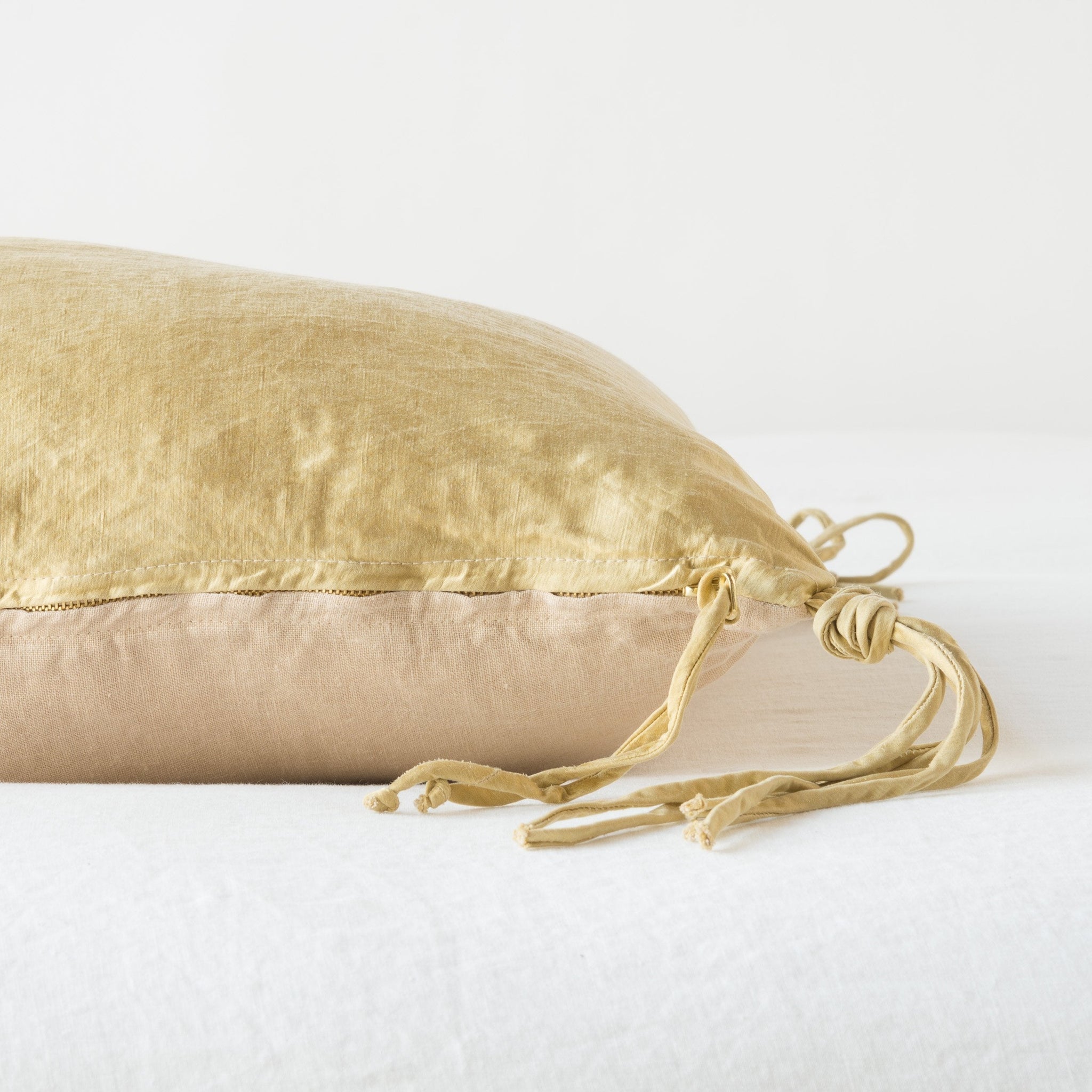 Honeycomb | Close-up side vew of Taline throw pillow featuring brass zipper with charmeuse pull and linen back - honeycomb.