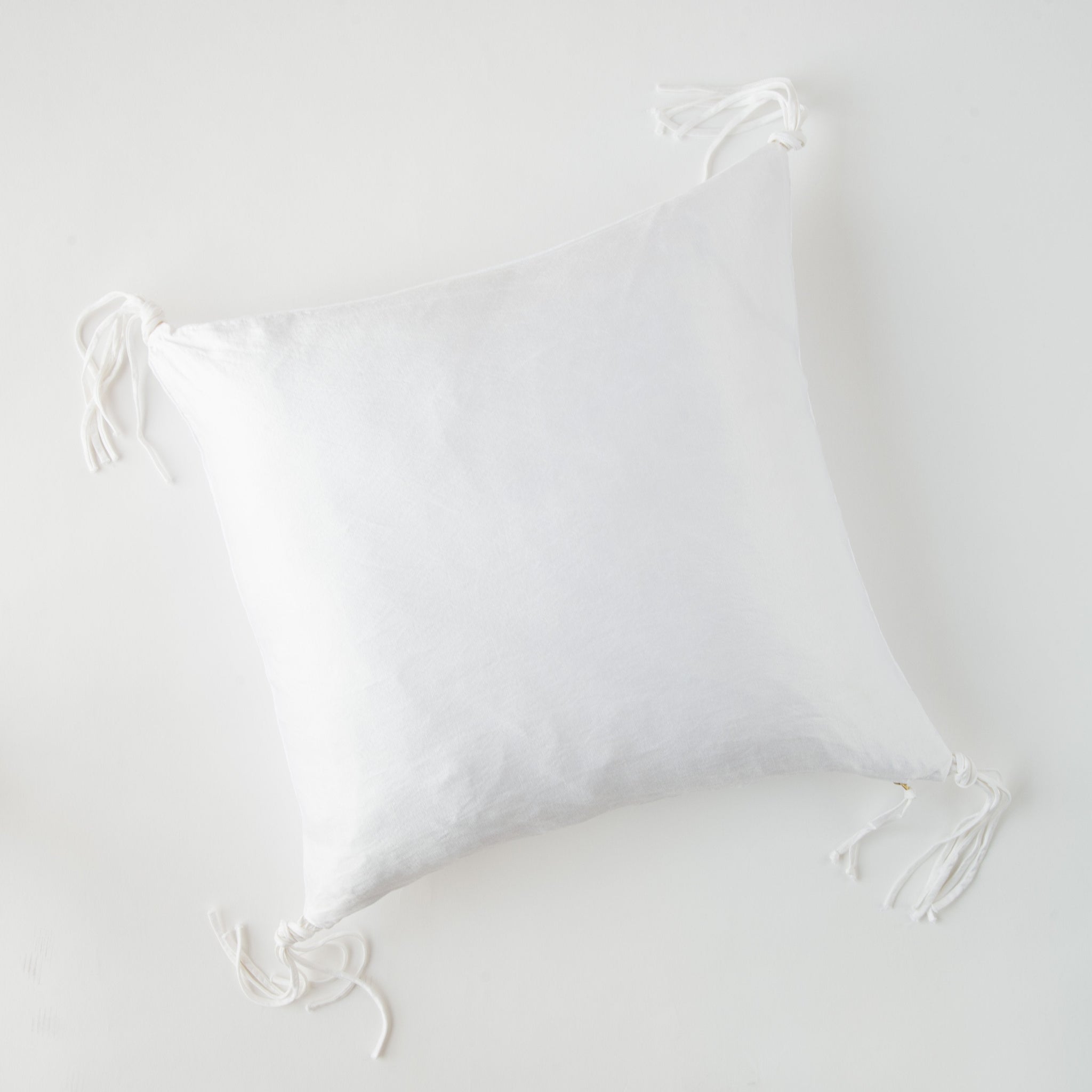 Taline Throw Pillow | White | overhead view on white background.