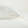 Taline Throw Pillow | Winter White | Close-up side vew featuring brass zipper with charmeuse pull and linen back.