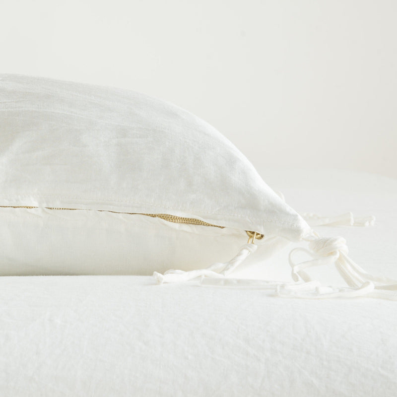 Taline Throw Pillow | Winter White | Close-up side vew featuring brass zipper with charmeuse pull and linen back.