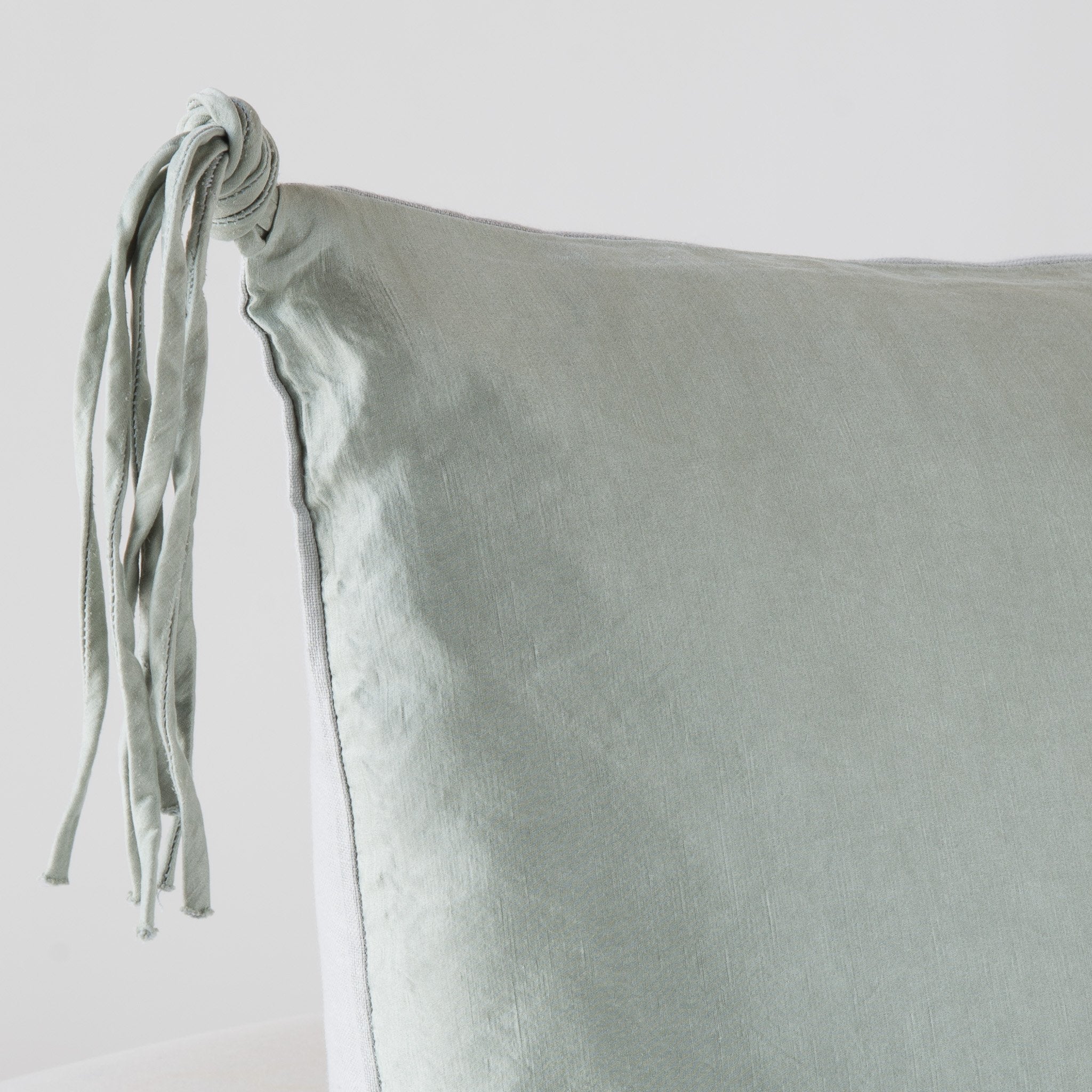 Taline Sham | Mineral | Corner detail close-up, highlighting hand-tied charmeuse tassel.