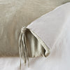 Taline Blanket | Fog | Close up of blanket, with a corner turned back to showcase the midweight linen back and corner tassel - overhead view.