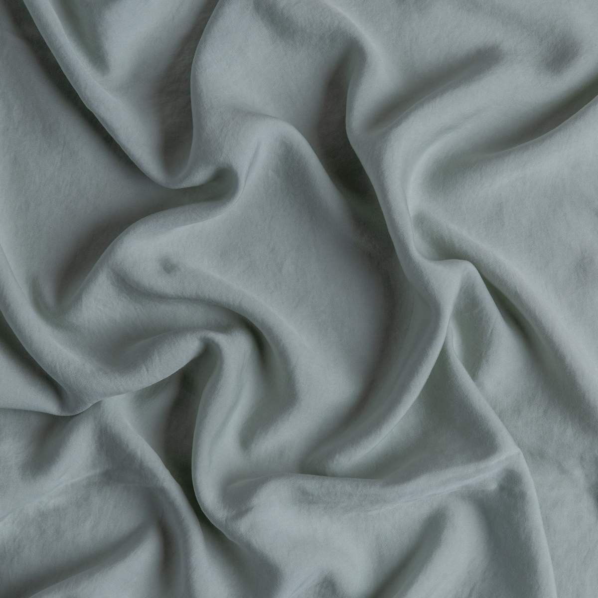 Tencel™ Swatch Card | Eucalyptus | A close up of tencel™ fabric in eucalyptus, a soft light green.