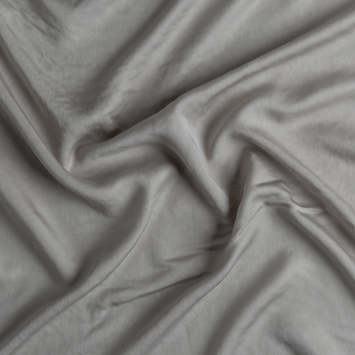 Tencel™ Swatch Card | Fog | A close up of tencel™ fabric in fog, a neutral-warm, soft mid-tone grey.