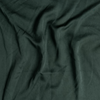 Madera Luxe Twin Fitted Sheets | Juniper | A close up of tencel™ fabric in Juniper, a deep green tone.