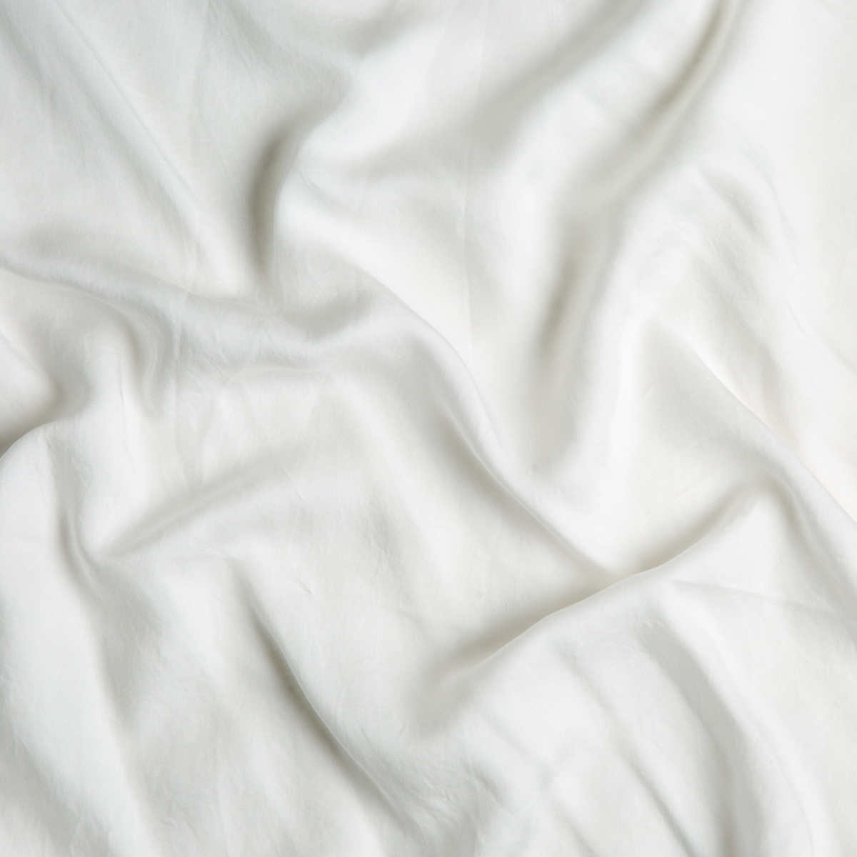 Tencel™ Swatch Card | Winter White | A close up of tencel™ fabric in winter white, softer and warmer in tone than classic white.