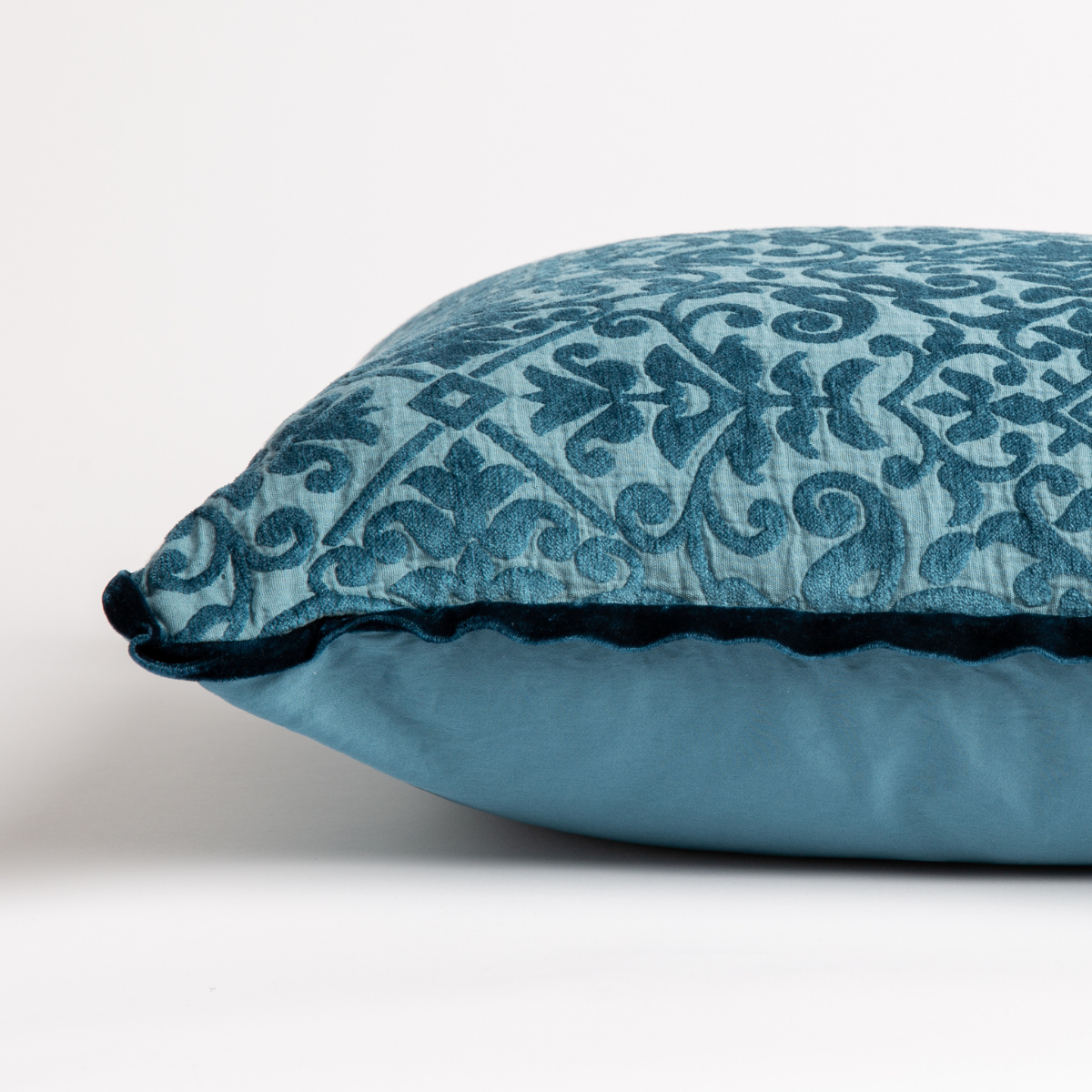 Vienna Throw Pillow | side view of 18x18 pillow shows cotton sateen back and silk velvet trim detail — close up against a white background. 