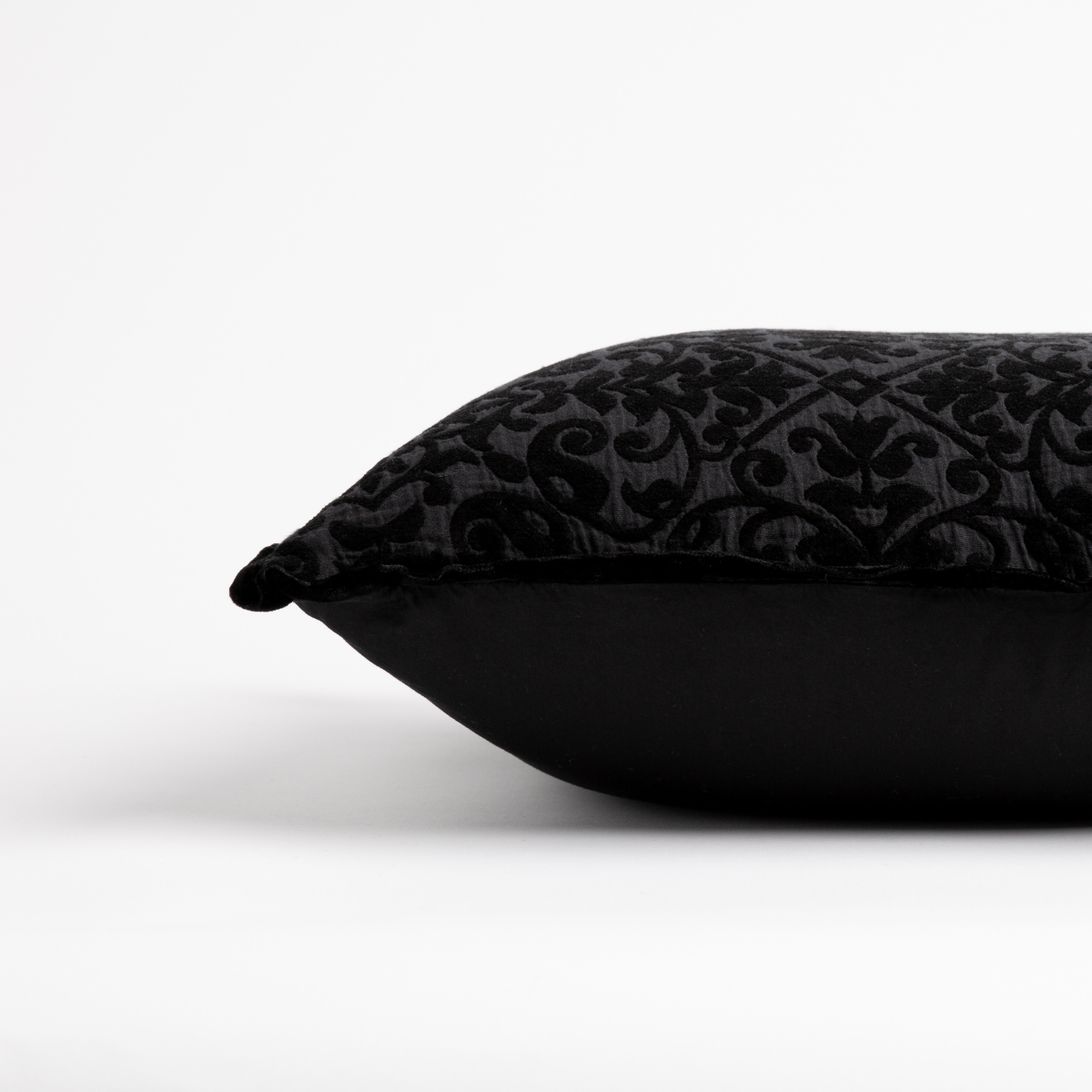 Vienna Throw Pillow | side view of 18x18 pillow shows cotton sateen back and silk velvet trim detail — close up against a white background. 