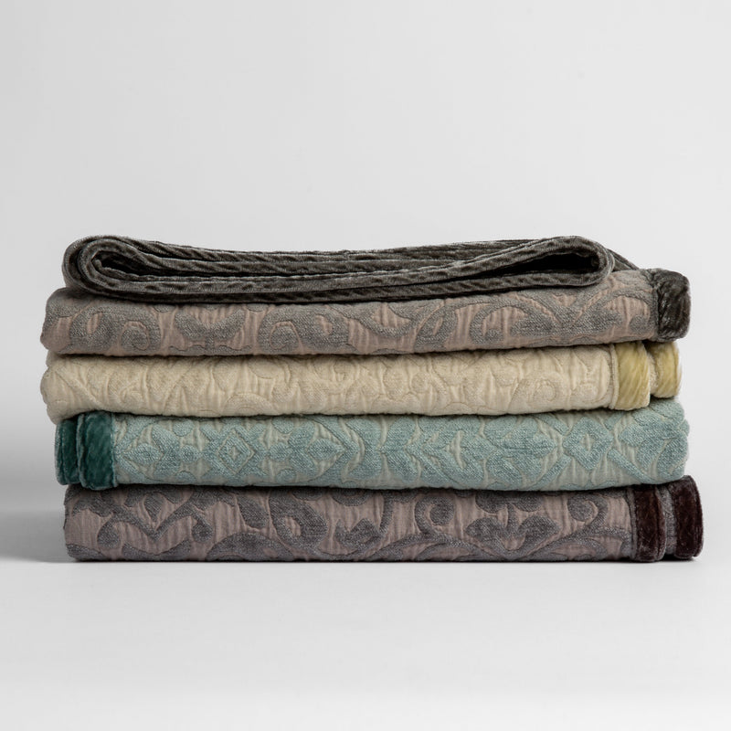 Vienna Baby Blanket | stack of cotton chenille baby blankets in fog, parchment, eucalyptus and moonlight - silk velvet edges alternating sides of the stack.