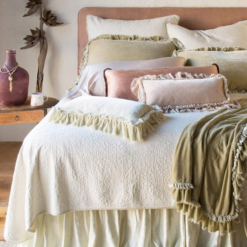 Vienna Coverlet and shams add beautiful jacquard texture under ruffled silk velvet, in soft cream, pink and gold tones - end of bed view.