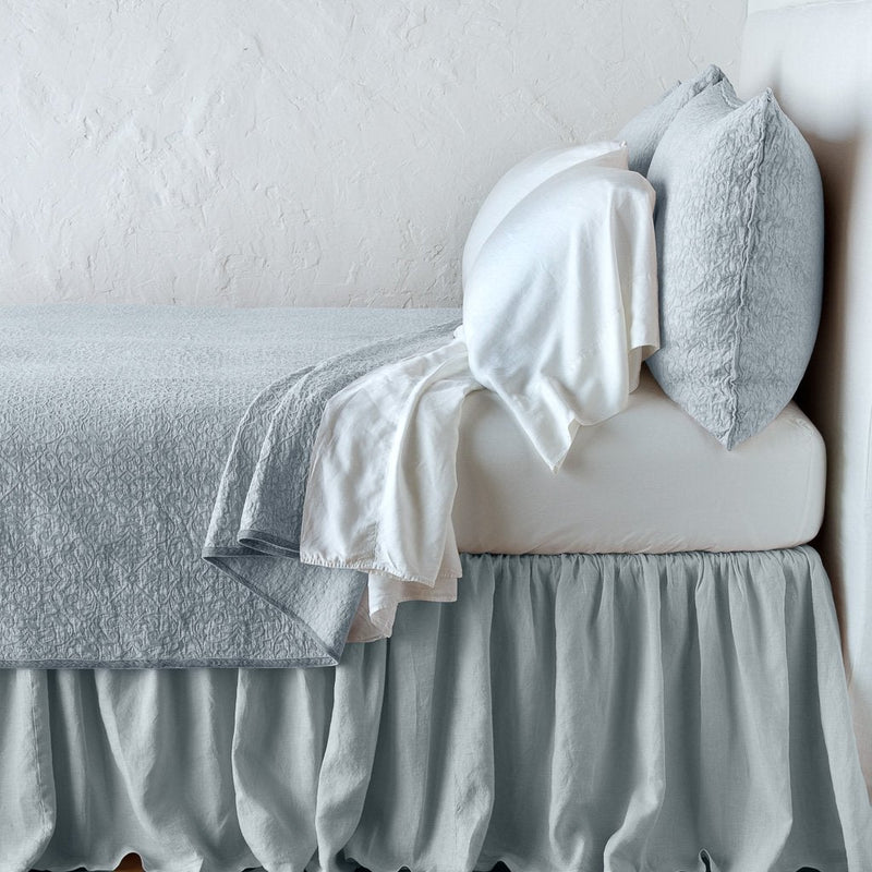 Cloud | Vienna coverlet and matching sham over white sheeting - cloud, side view.