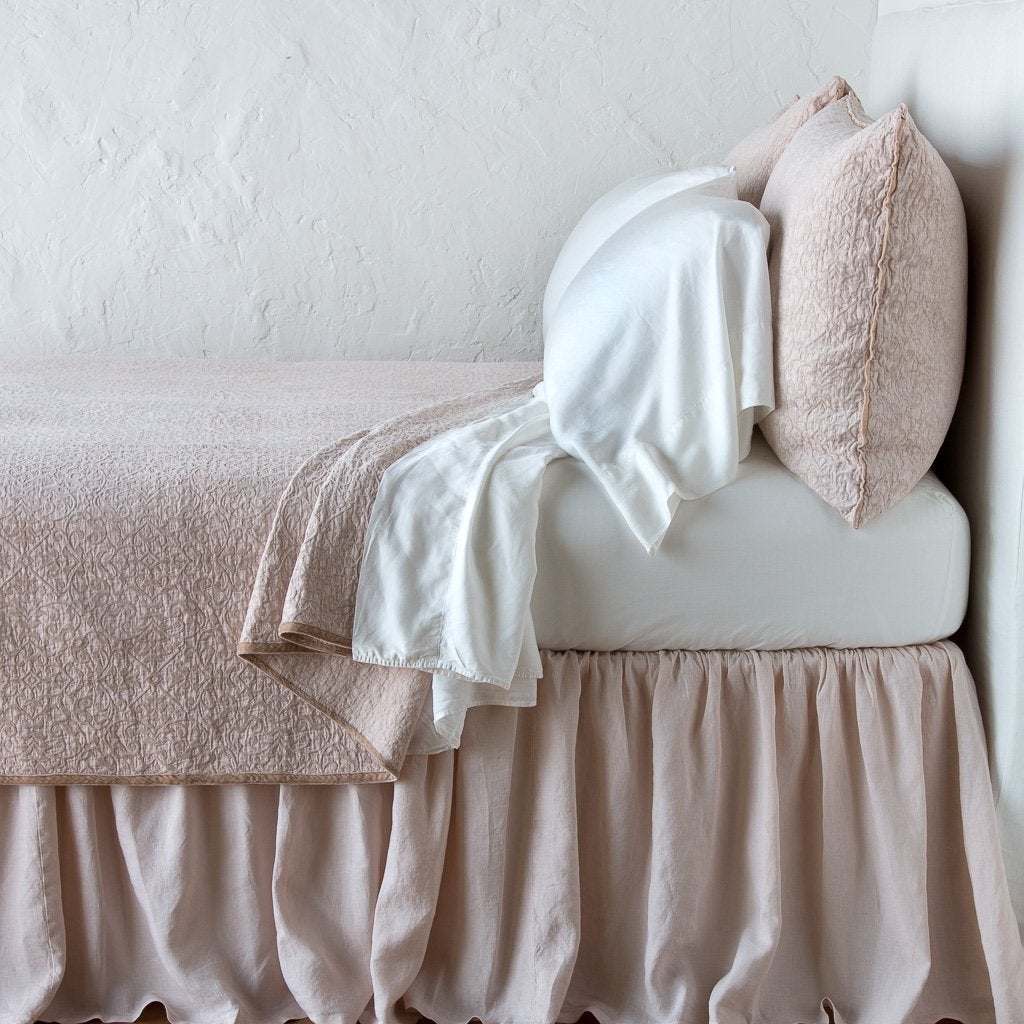 Pearl | Vienna coverlet and matching sham over white sheeting - pearl, side view.