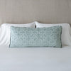 Vienna Throw Pillow | Eucalyptus | 16x36 pillow leaning upright against white sleeping pillows on a neutral headboard.