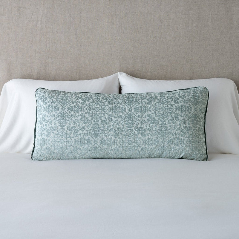 Vienna Throw Pillow | Eucalyptus | 16x36 pillow leaning upright against white sleeping pillows on a neutral headboard.
