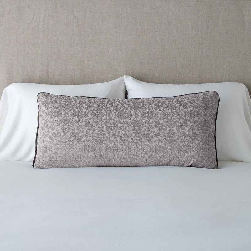 Vienna Throw Pillow | Fog | Vienna 16x36 pillow leaning upright against white sleeping pillows on a neutral headboard - fog.