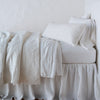 Vienna Throw Pillow | Winter White | Vienna 16x36 and matching coverlet over white sheeting - winter white, side view.