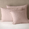 Vienna Sham | Rouge | Cotton chenille jacquard shams leaning upright against a neutral headboard.